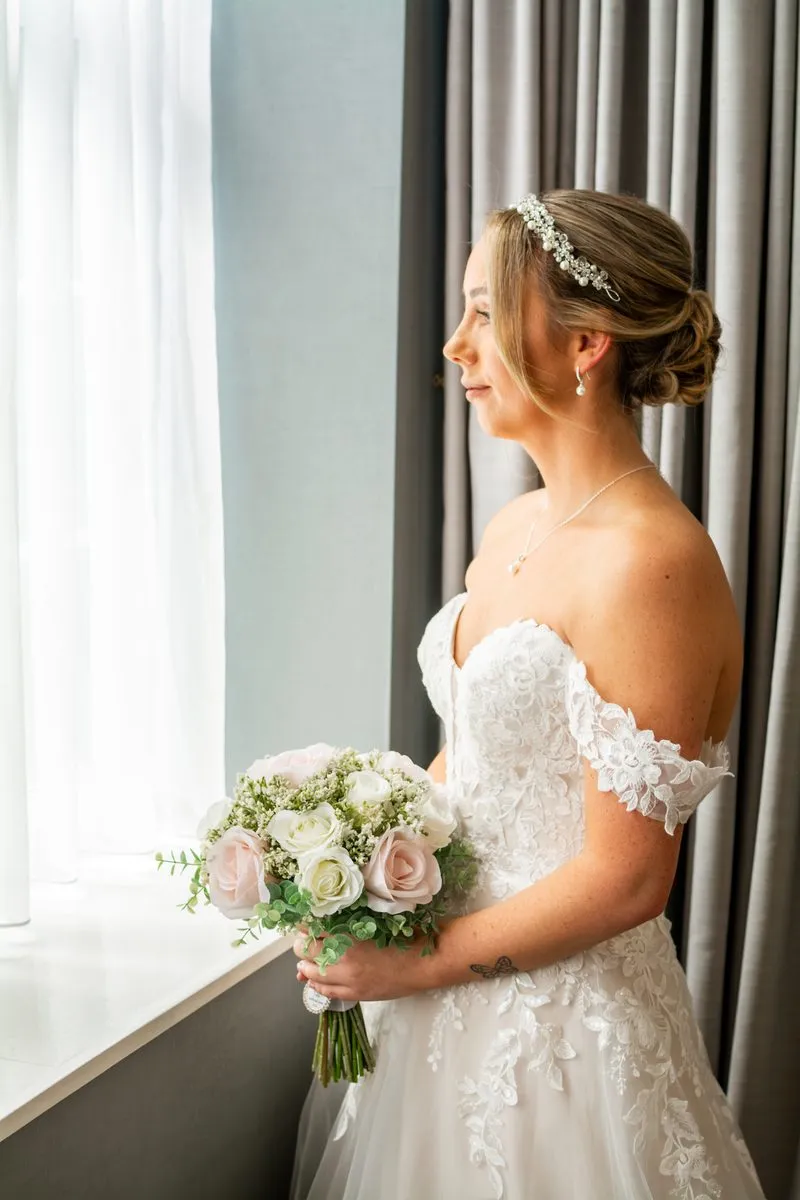 The bride in a quiet moment by the window