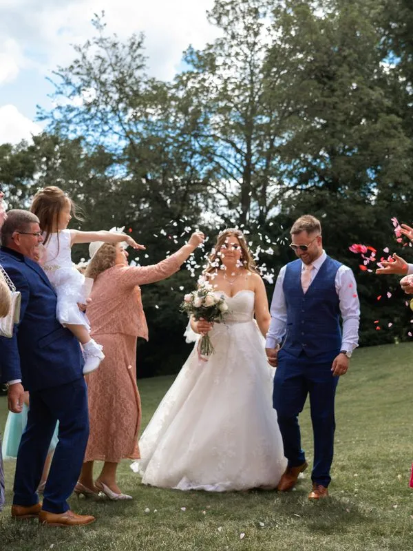 Confetti moment as the couple walk through their guests